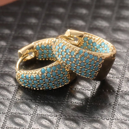 Goudkleurige oorringen met turkooizen kralen | Goud