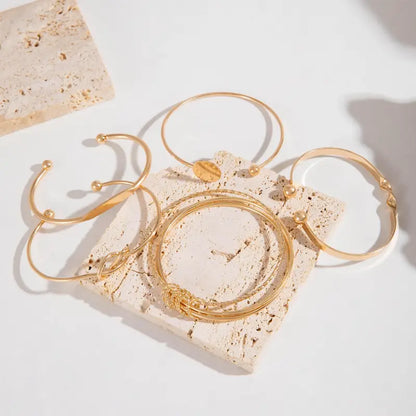 Elegante armbandenset met knoopmotief | Goud