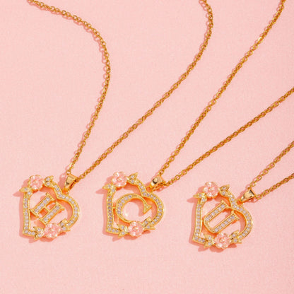 Ketting met initiaal en bloemenbedel | Goud