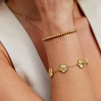 Florielle armband met bloemenbedel | Goud